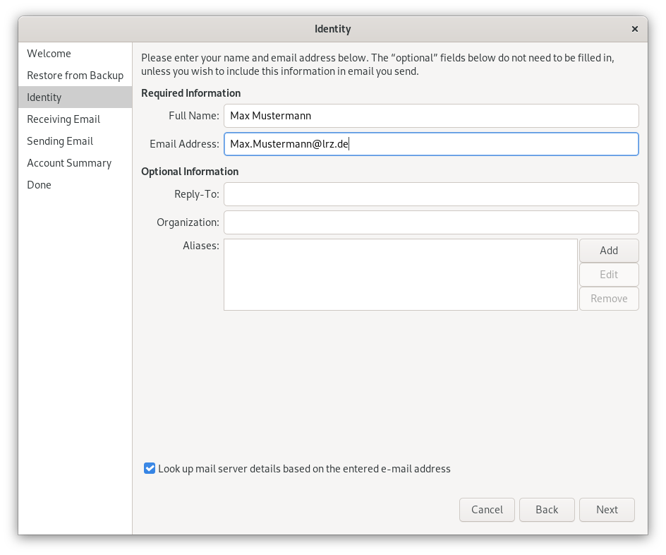 Window Identity. Left column with 7 points, selected point 3, Identity. On the right, the main field. Please enter your name and email address below. The 'optional' fields do not need to be filled in, unless you wish to include this information in email you send. Required Information. Full name, input field Max Mustermann. Email Address, input field Max.Mustermann At lrz.de. Optional Information (labeled 'Optional' above). Reply-To, empty input field. Organization, empty input field. Aliases, larger empty input field, to the right of it one below the other 3 buttons, Add, 2 times dimmed Edit, Remove. Pretty far down, box with check mark, Look up mail server details based on the entered e-mail address. At the bottom right, 3 buttons Cancel, Back, Next.